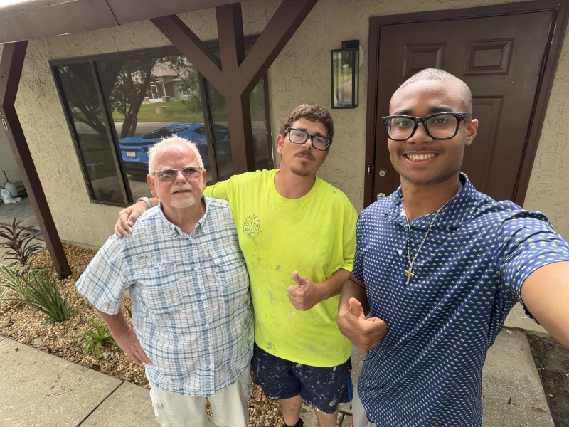 The Brevard Buyers Group crew outside a refreshed front entry with new trim and landscaping