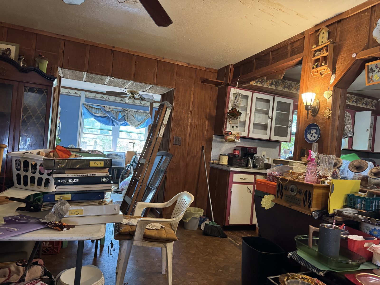 Cluttered wood-panelled interior, bought as-is