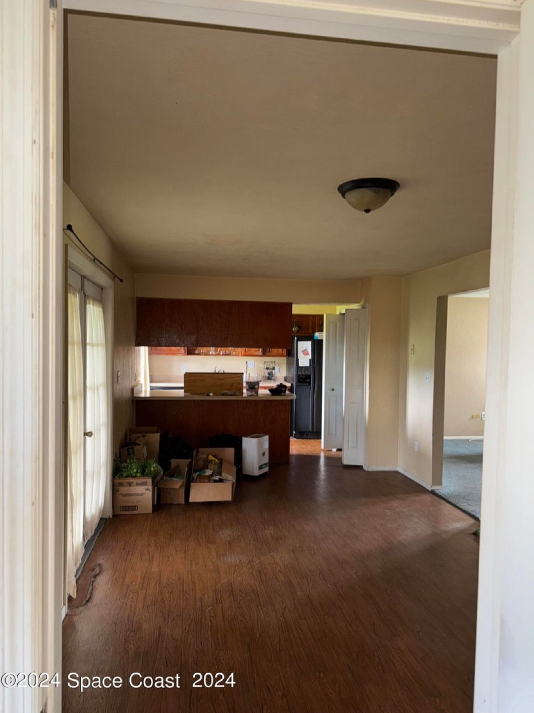 Tackett kitchen before — dated cabinets, worn flooring, old appliances